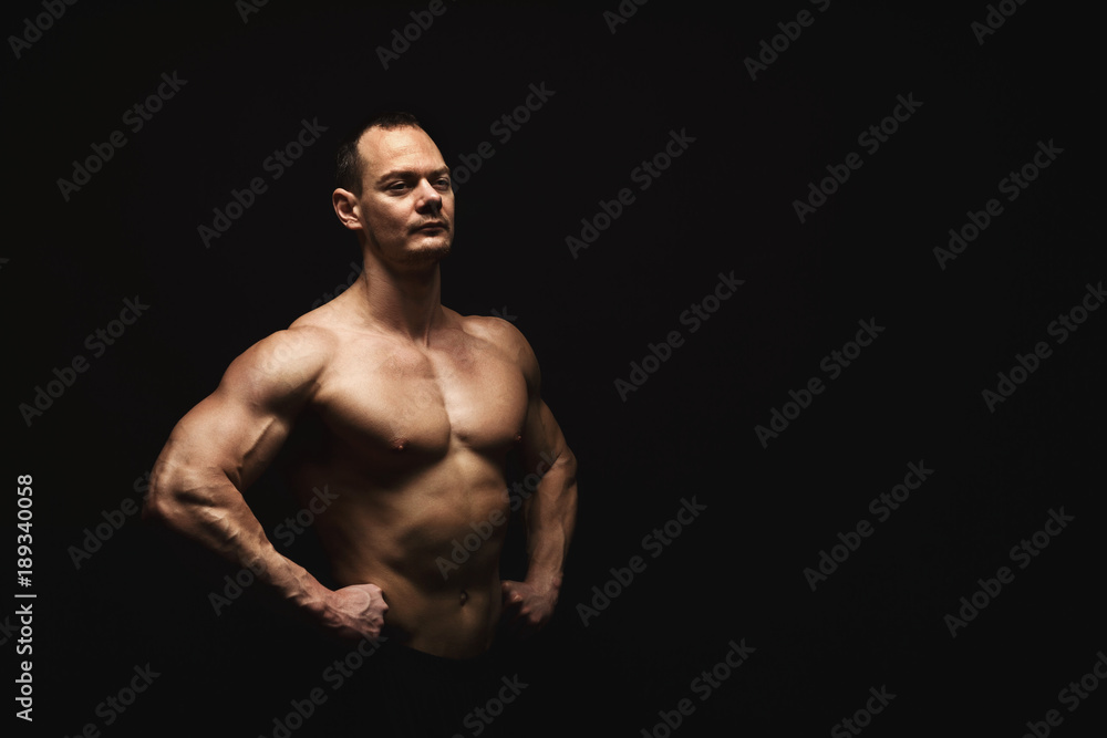 Fototapeta premium Strong athletic man showes naked muscular body