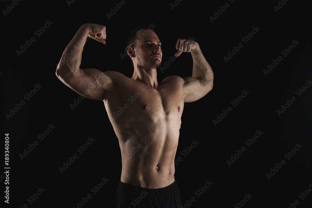 Strong athletic man showes naked muscular body Strong athletic man showes naked muscular body