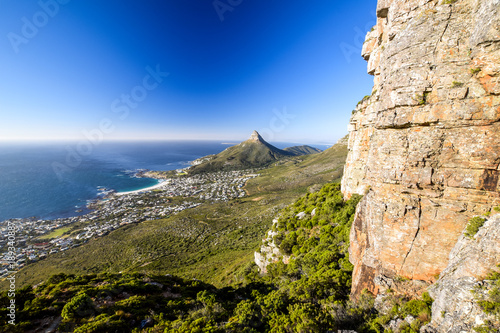 Stunning panorama view of the suburb of Camps Bay and Lion's Head and Table mountain (right) in Cape Town, South Africa. Seen from Kasteelspoort Hiking Trail, part of Table Mountain National Park.