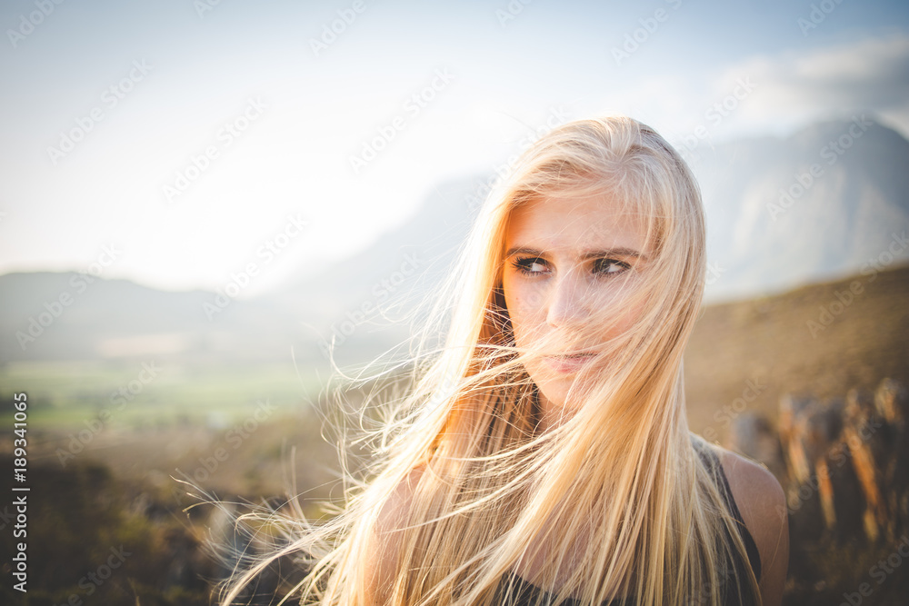 Portrait of a beautiful blond female model in a natural setting with stunning back light Portrait of a beautiful blond female model in a natural setting with stunning back light