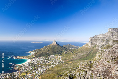 Stunning panorama view of the suburb of Camps Bay and Lion's Head and Table mountain (right) in Cape Town, South Africa. Seen from Kasteelspoort Hiking Trail, part of Table Mountain National Park.
