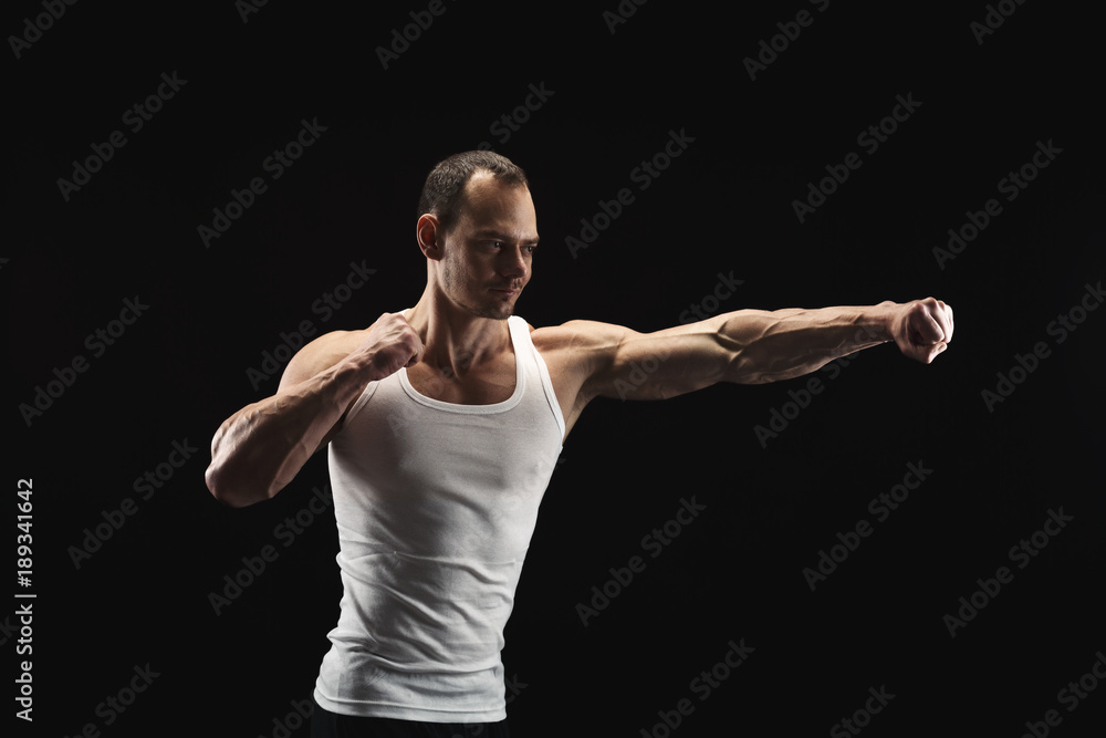 Strong athletic man showes naked muscular body