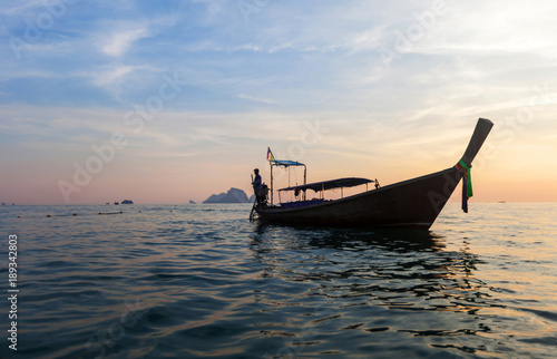 Traditional thai boats at sunset beach. Ao Nang, Krabi province.