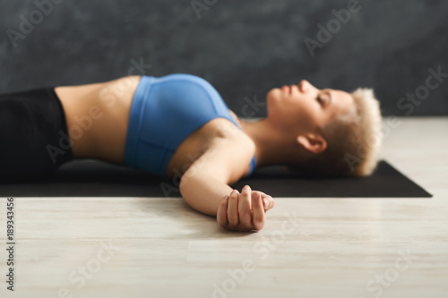 Woman having rest after training yoga in gym