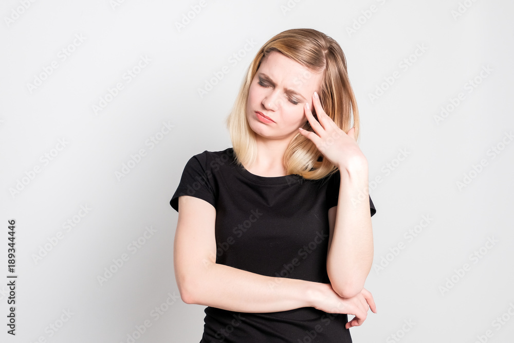 Beautiful blonde girl holding head in pain Beautiful blonde girl holding head in pain