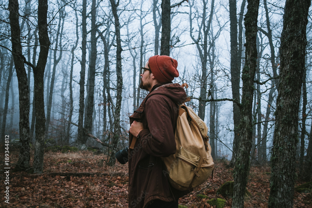 man walking on a dark path through a spooky forest