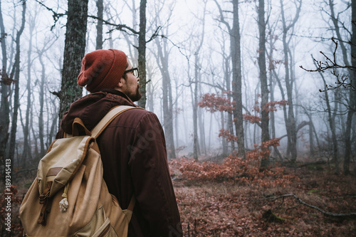 man walking on a dark path through a spooky forest © YURII Seleznov