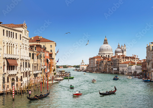 Venice, the Grand canal, the Cathedral of Santa Maria della Salute and gondolas with tourists