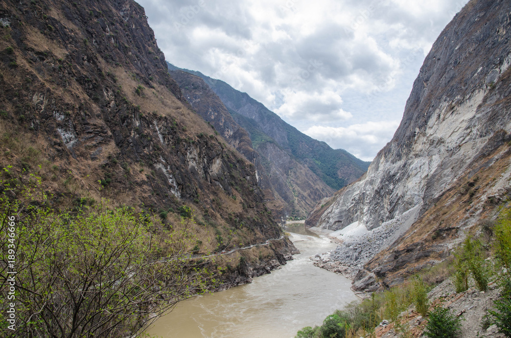 The torrential flow through the hills in Tibet The torrential flow through the hills in Tibet