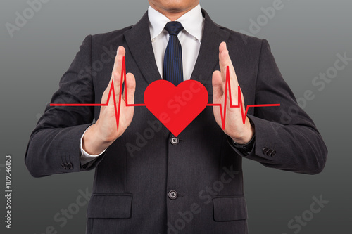 Doctor with heart pulse graphic.