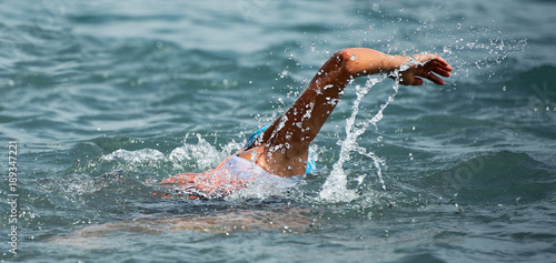 Man swimmer swimming crawl in blue sea,training for triathlon © pavel1964