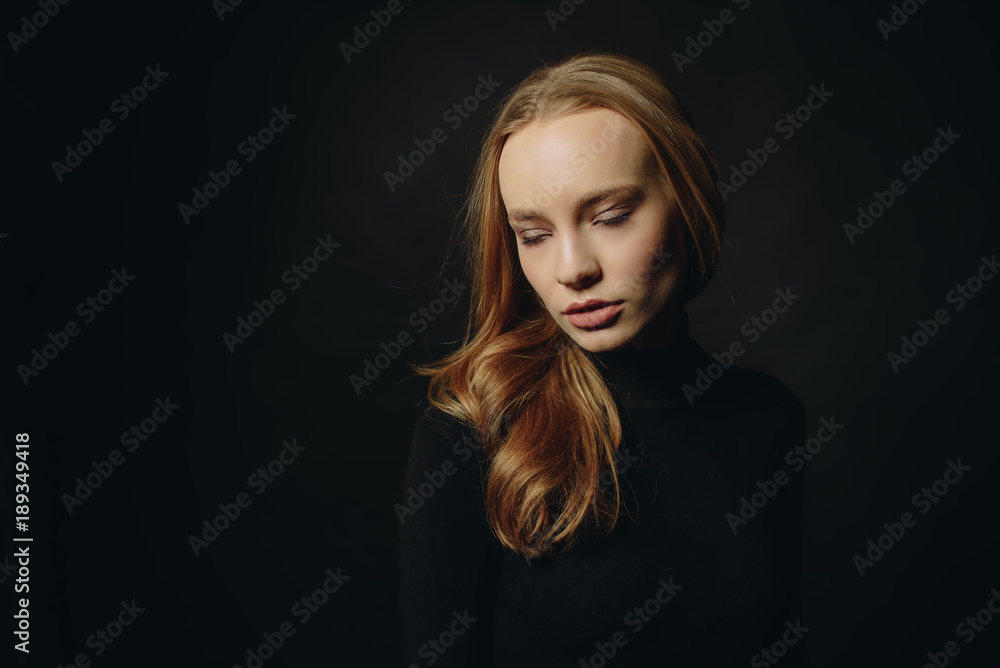 Fototapeta premium Theater days. Portrait of beautiful girl in profile. Young gorgeous caucasian girl in casual clothes on the chair, studio shot. Stunning sensual young woman.