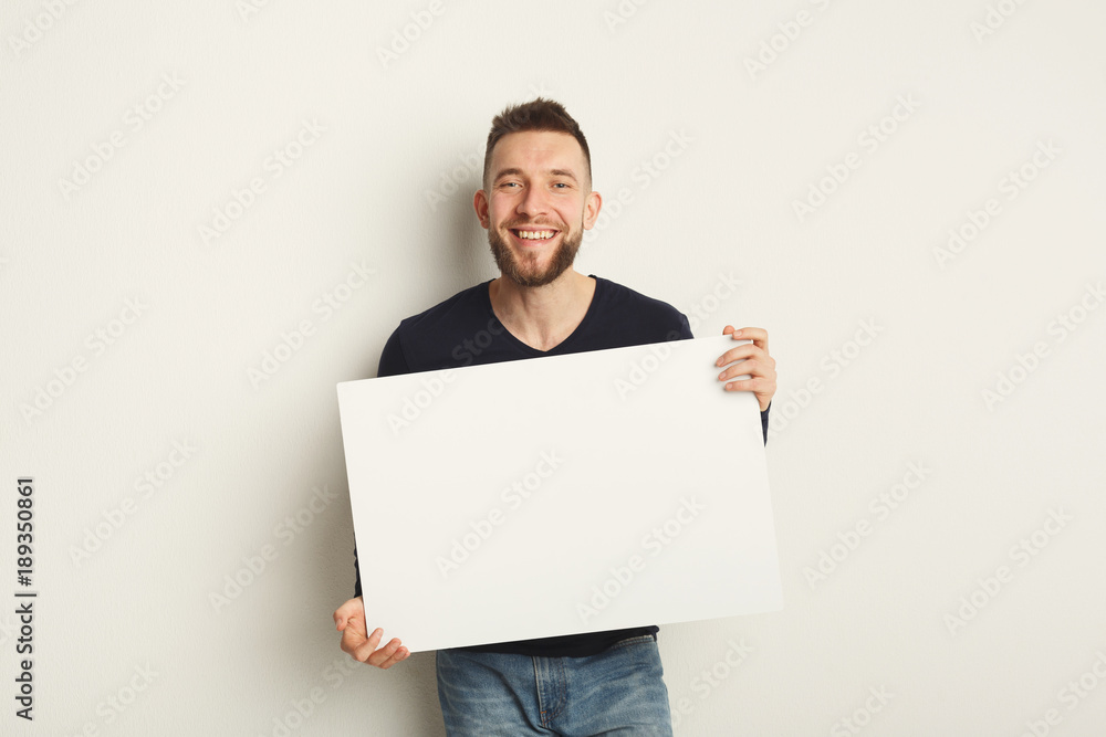 Young bearded man with blank white paper Young bearded man with blank white paper