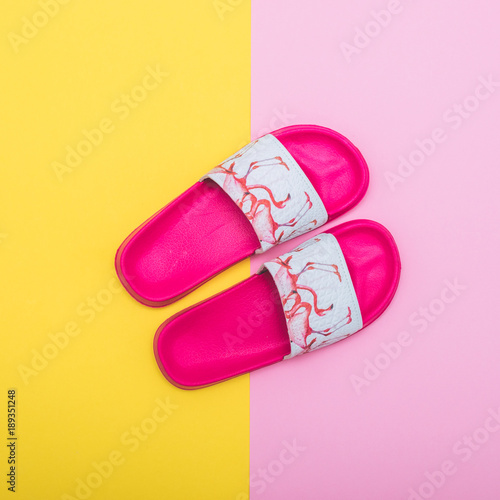 slippers on a pink and yellow color background. creative minimalism
