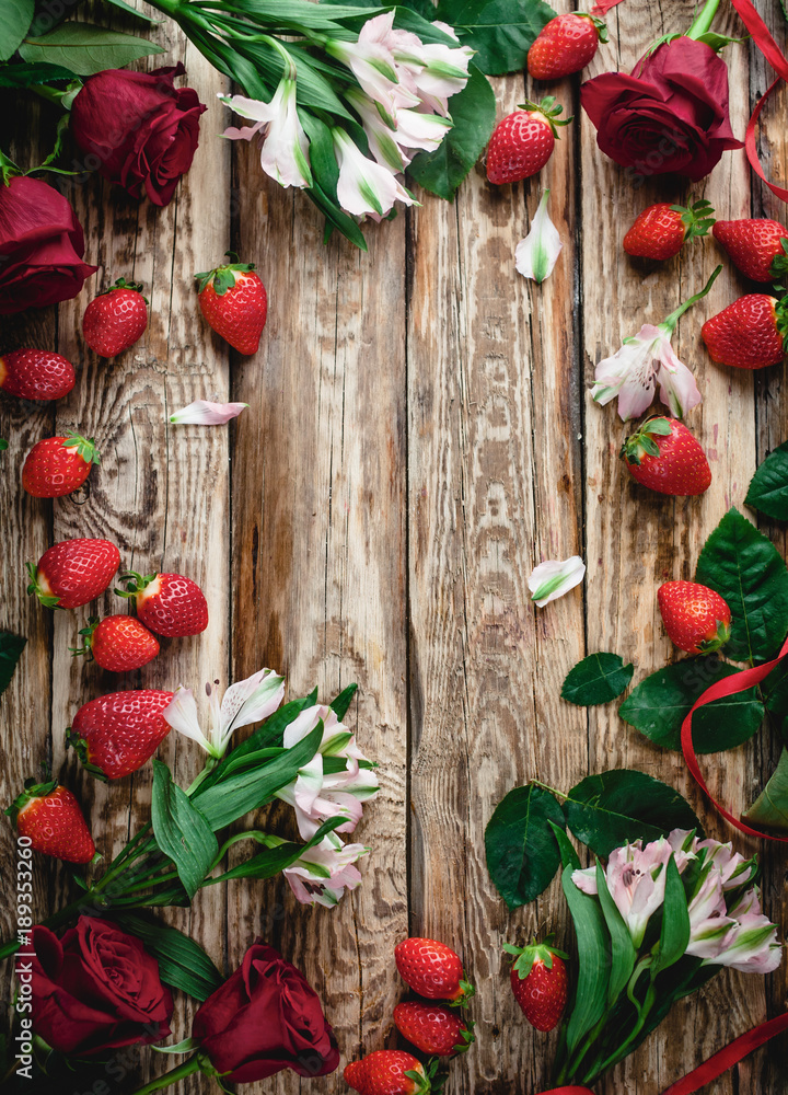 top view of strawberries and flowers on wooden shabby background, valentines background top view of strawberries and flowers on wooden shabby background, valentines background