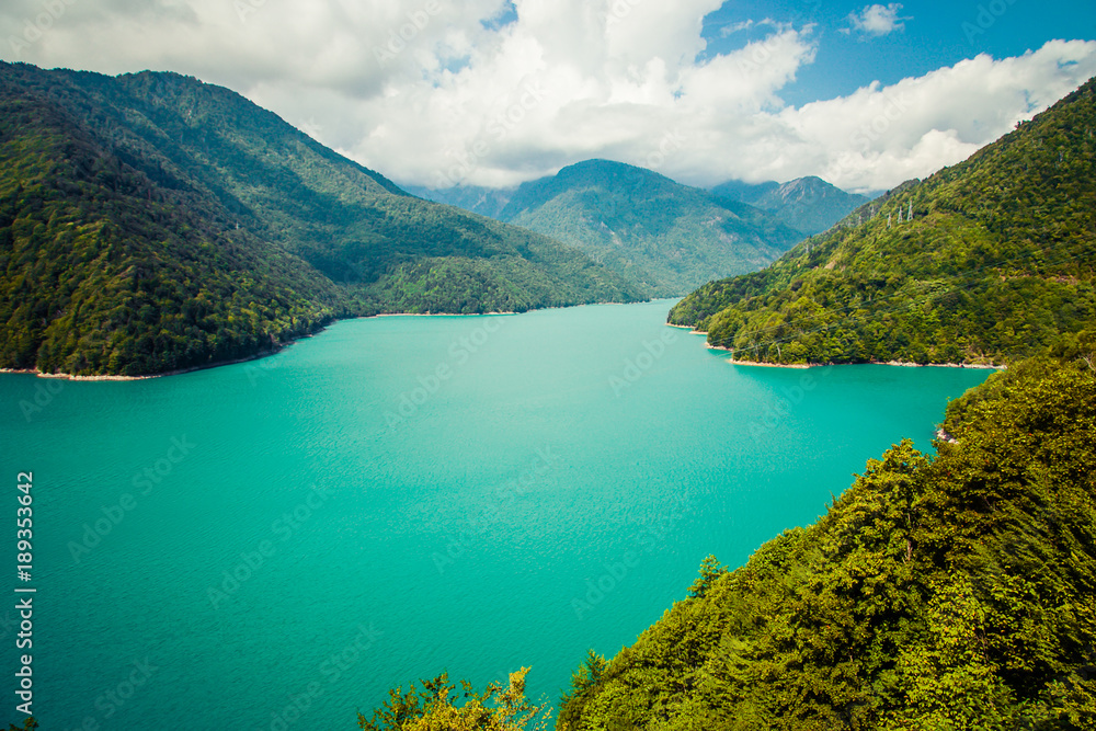 The Enguri Dam -   hydroelectric dam on the Enguri River in Georgia. HES - amazing turquoise water. with hills.