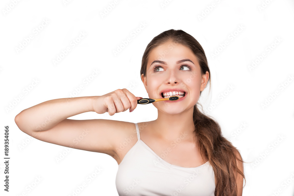 Woman cleans her teeth with a toothbrush. Close-up portrait on a white background. Woman cleans her teeth with a toothbrush. Close-up portrait on a white background.