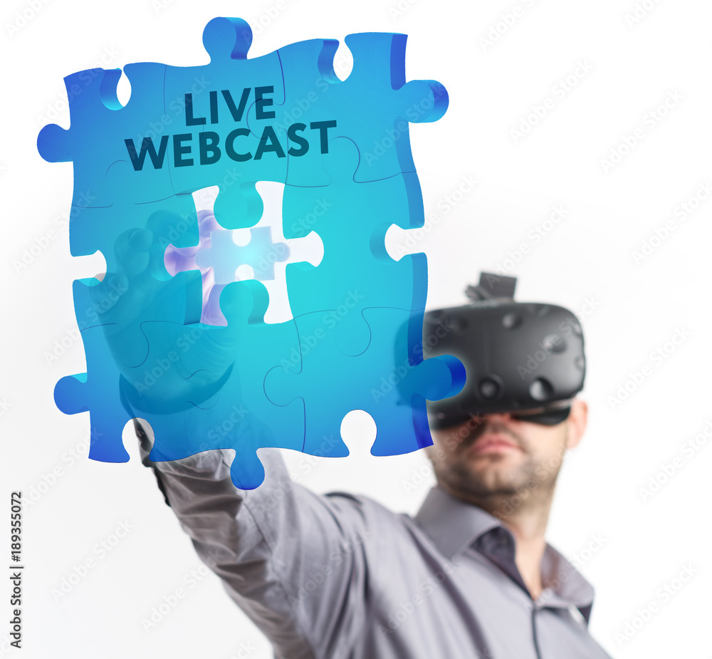 The concept of business, technology, the Internet and the network. A young entrepreneur working on a virtual screen of the future and sees the inscription: Live webcast The concept of business, technology, the Internet and the network. A young entrepreneur working on a virtual screen of the future and sees the inscription: Live webcast