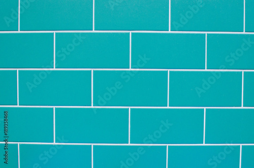Texture of light blue tiles on the wall