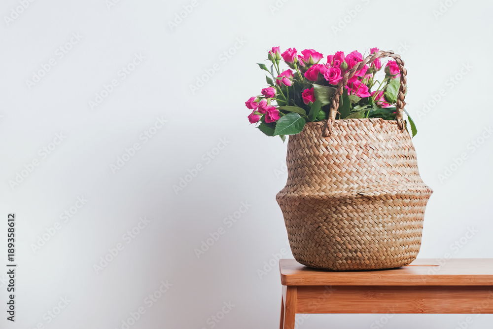 Pink roses in a straw basket Pink roses in a straw basket