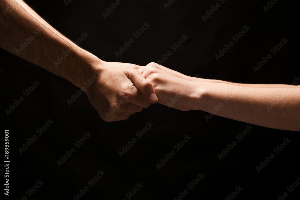 Hands of man and woman in love, isolated on black Hands of man and woman in love, isolated on black