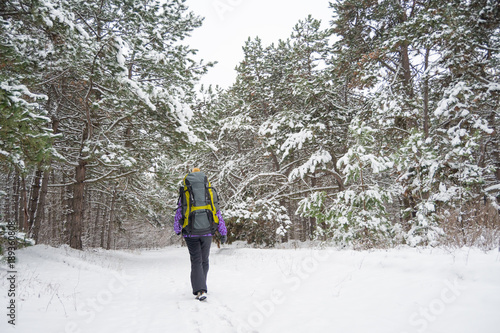 Woman Hiking with Big Backpack in Beautiful Winter Forest © Maksym Protsenko