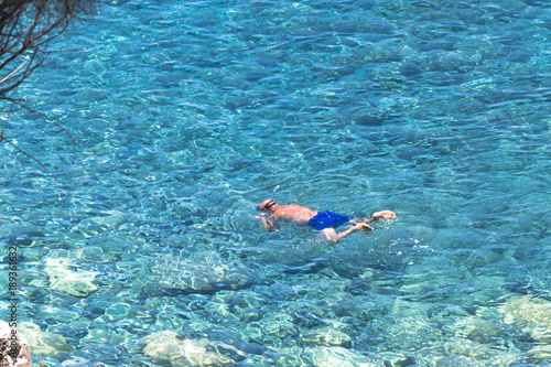 Top view of a man swimming in transparent and crystal clear water Amantea (calabria)