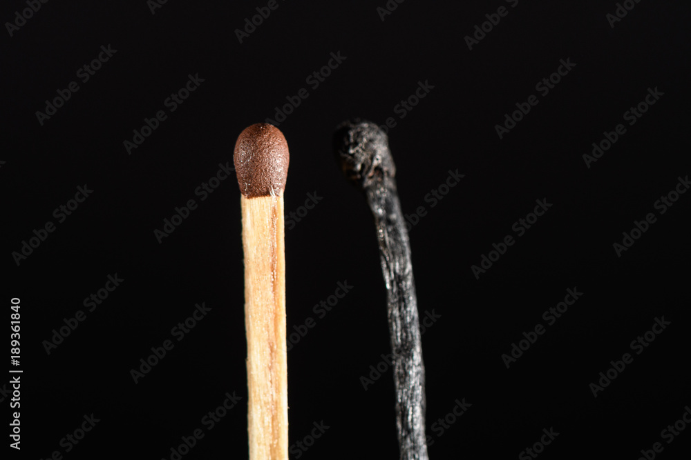 A match near completely burned on black background closeup A match near completely burned on black background closeup