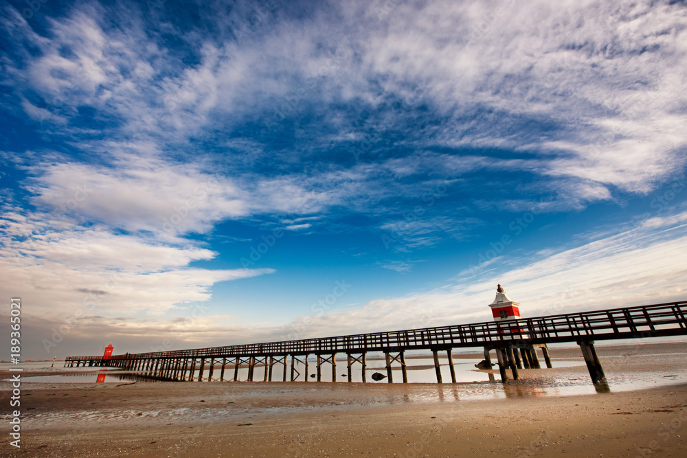 Fototapeta premium Pier and low tide in Lignano, Friuli Venezia Giulia, Italy.