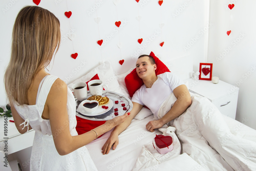 Valentines day breakfast bed lovely caucasian couple celebration red heart