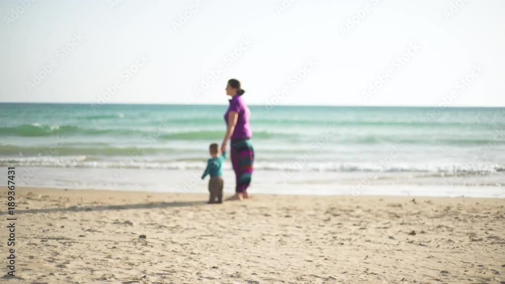 Young family in the beach playing and enjoying together, smiling, in a loving way Young family in the beach playing and enjoying together, smiling, in a loving way
