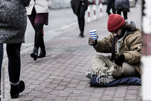 Hopeless beggar on the sidewalk photo