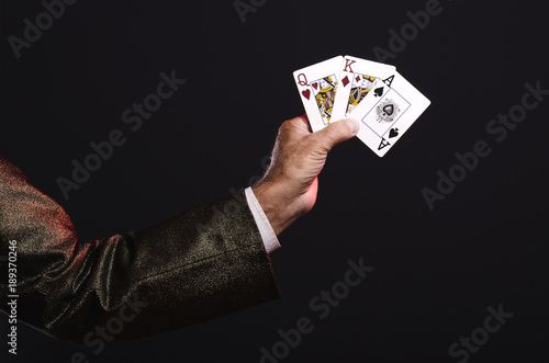 Magician shows trick with playing cards. Manipulation with props. Sleight of hand.