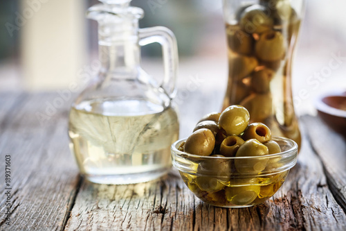 Olives and olive oil on a wooden table