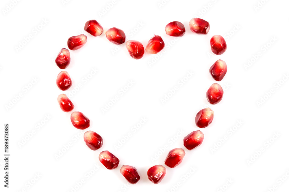 Fresh raw seeds of pomegranate fruit with heart symbol isolated on white background, Heart symbol made from seeds of pomegranate fruit on white background, with clipping path Fresh raw seeds of pomegranate fruit with heart symbol isolated on white background, Heart symbol made from seeds of pomegranate fruit on white background, with clipping path
