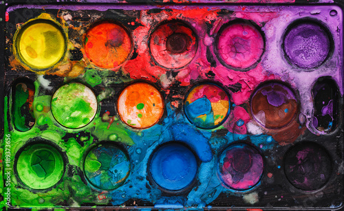 Black watercolor palette with mixed bright colors