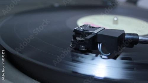 Record player head playing vinyl as macro view