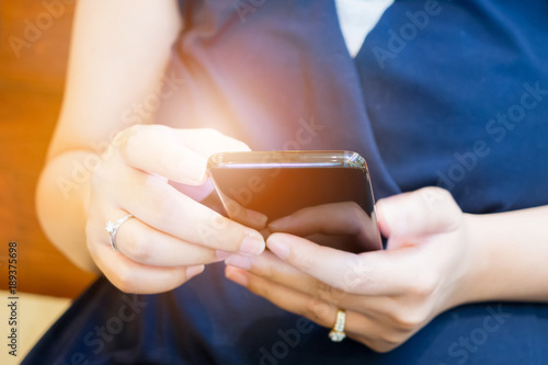 Close up woman using mobile smart phone in restaurant or cafe coffee shop