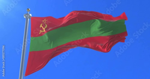 Flag of Transnistria waving at wind in slow with blue sky, loop photo