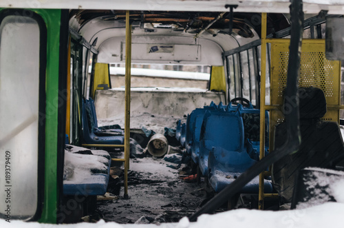 The abandoned passenger bus after the explosion. Inside, you can see broken armchairs and broken glass