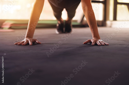 Closeup woman hand doing push ups exercise in a gym.