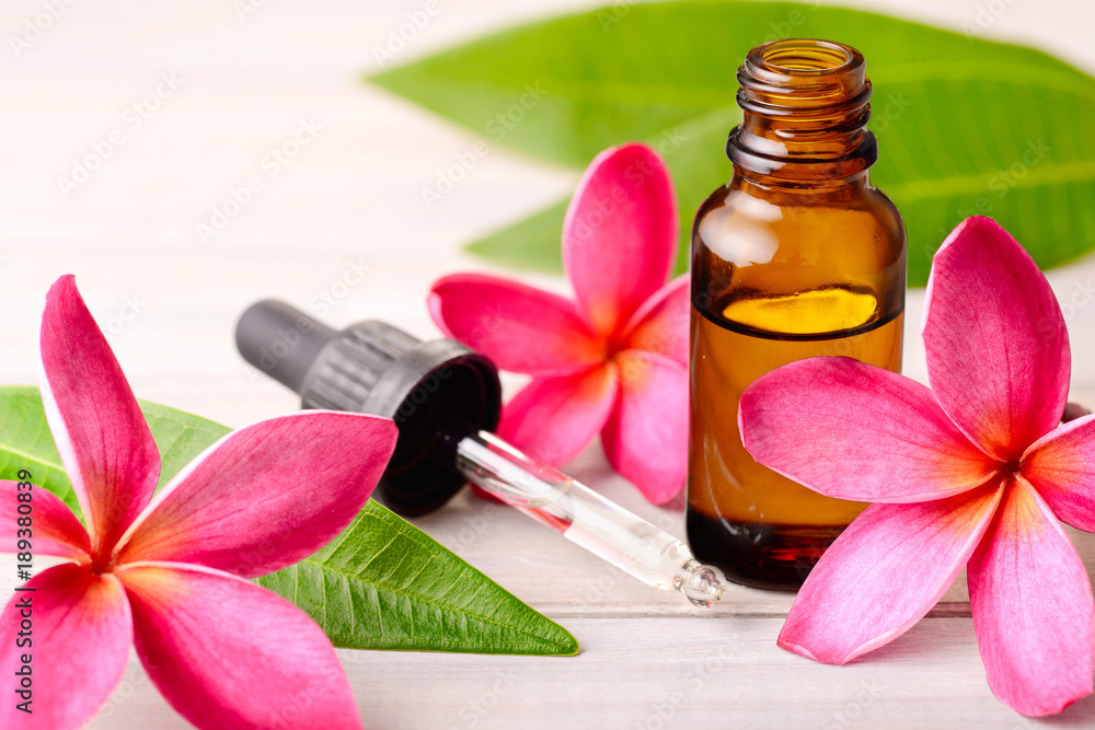 Plumeria Fragrance Oil Perfume and red plumeria flowers on the wooden table  Stock Photo | Adobe Stock