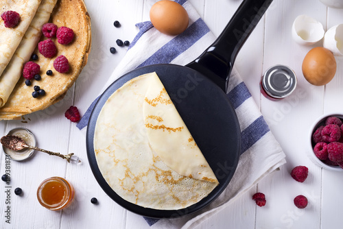 Preparing for pancakes with berries and jam photo