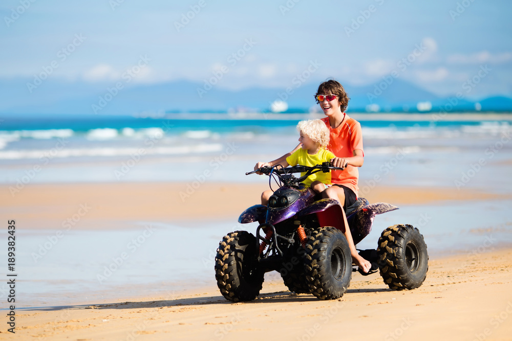 Kids on quad bike. Off road all terrain vehicle. Kids on quad bike. Off road all terrain vehicle.