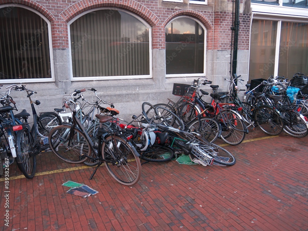 Fallen bicycles before wall by storm in Harlem Netherlands