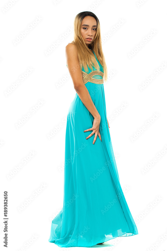 Full body portrait of a beautiful young african woman in a turquoise dress