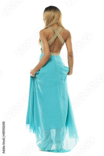 Full body portrait of a beautiful young african woman in a turquoise dress © Andrey_Arkusha
