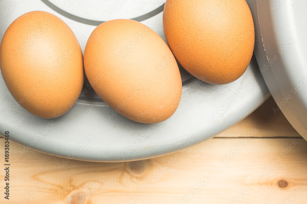 Yellow chicken eggs lie on pancakes from a sports barbell Yellow chicken eggs lie on pancakes from a sports barbell