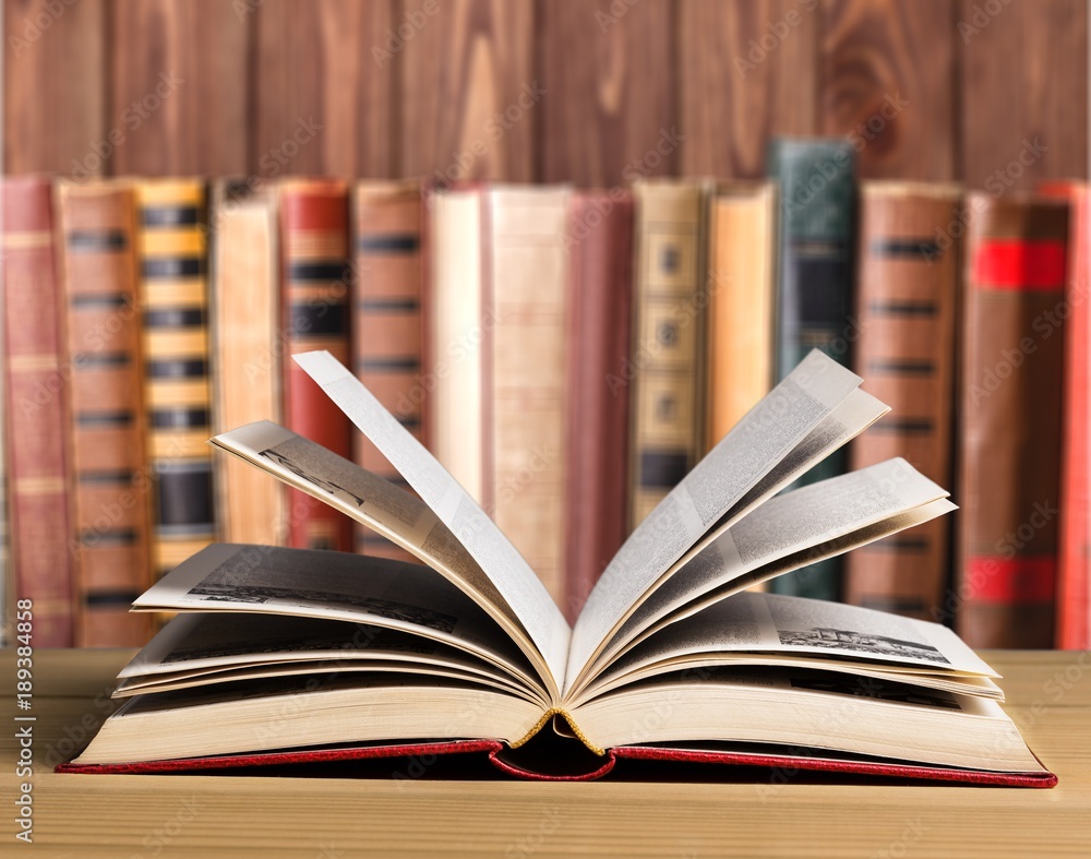 Open book on wooden table Open book on wooden table