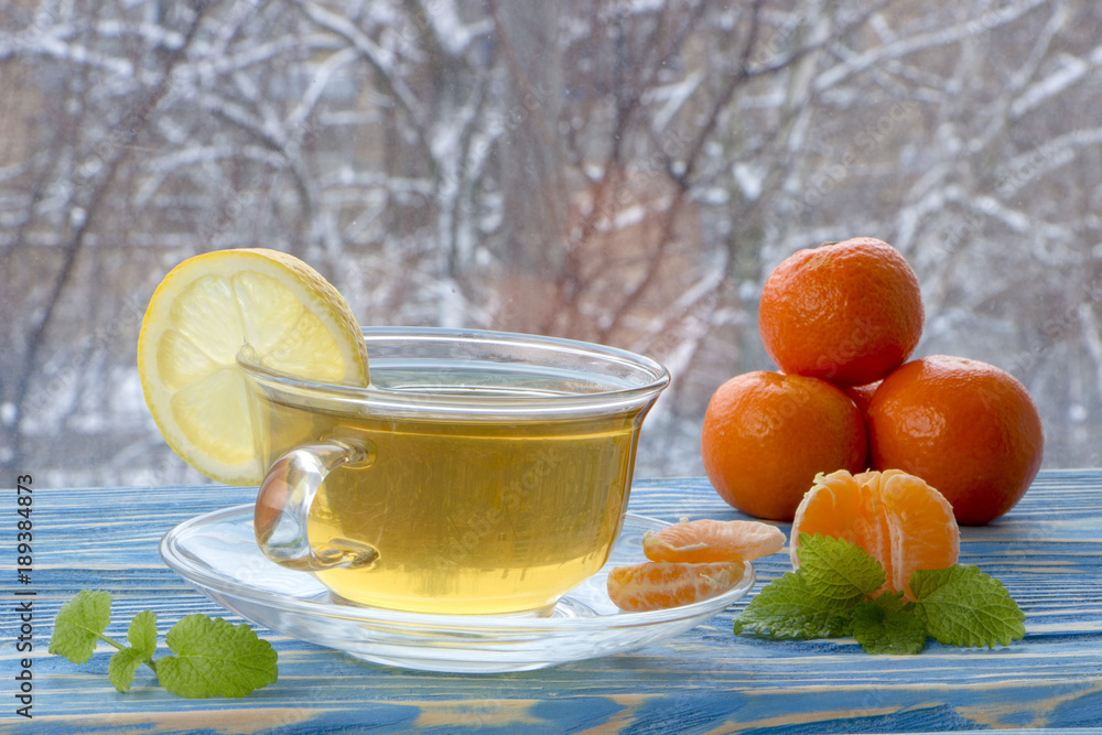 a cup of tea and sweets, on a blue wooden background